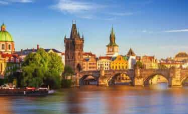 Charles Bridge is a medieval stone arch bridge that crosses the Vltava river in Prague